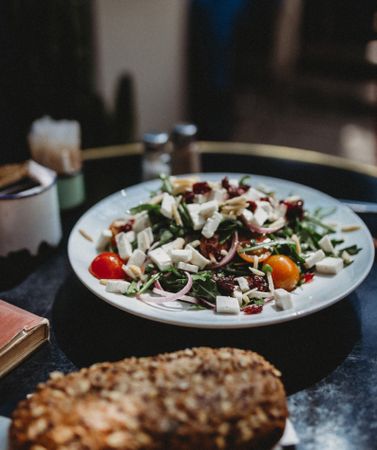 arabic salad with tomato, cheese and onion in a plate on table