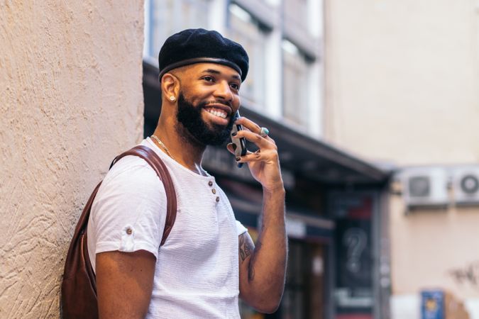 Stylish Black man talking on the phone outdoors in the city