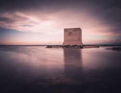 Wonderful watchtower in calm lake on cloudy day