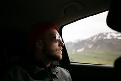 Male in sunglasses observing scenery from vehicle