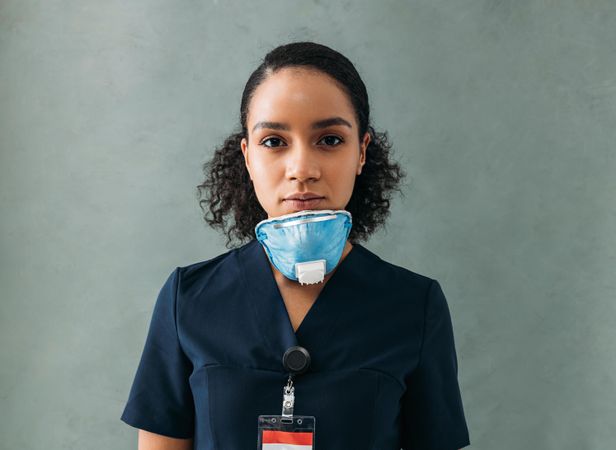 Female doctor with a medical mask under her chin
