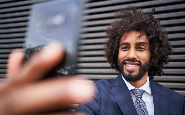 Joyful man taking selfie and smiling