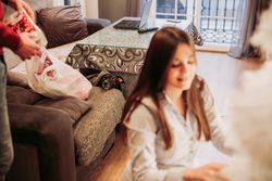 Young couple arranging Christmas tree at home
