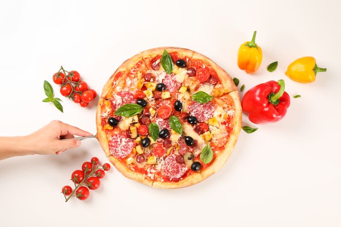 Female hand take pizza piece. Flat lay composition, copy space