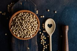 Chick peas in bowl on wooden serving board