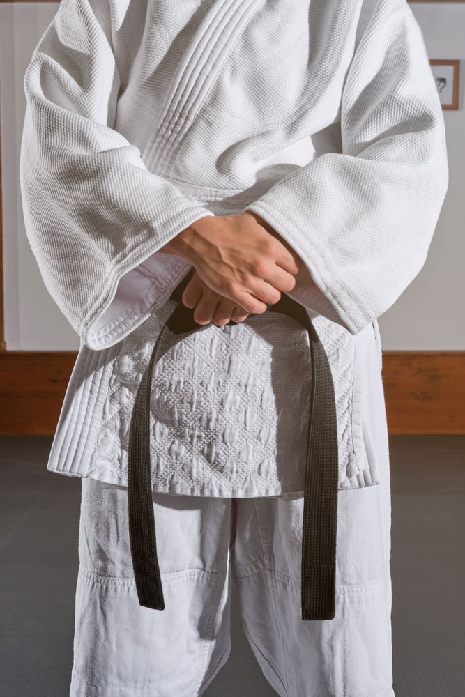 Crop man in kimono with crossed hands