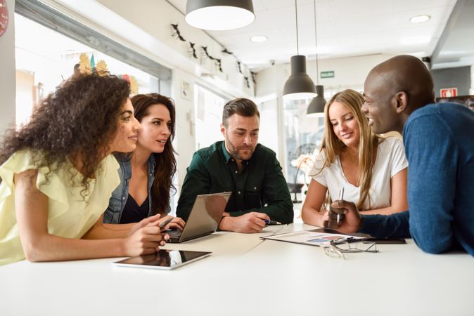 Group of people meeting around a table to go through charts for work