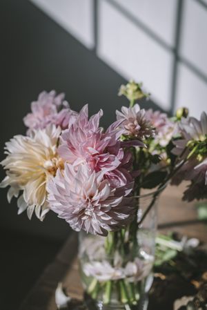 Bunches of flowers in vases on table