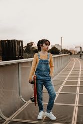 Girl with skateboard on walkway