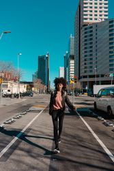 Woman with afro hair walking through the streets