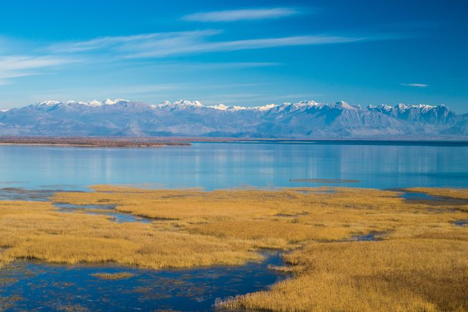 Calm lake and mountain ridge on sunny day