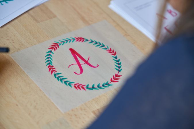 Calligraphic letter written in circle frame on paper