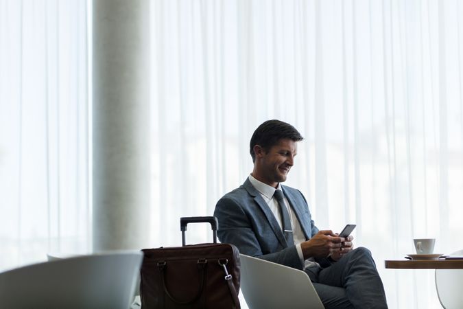 Businessman waiting for flight at airport lounge