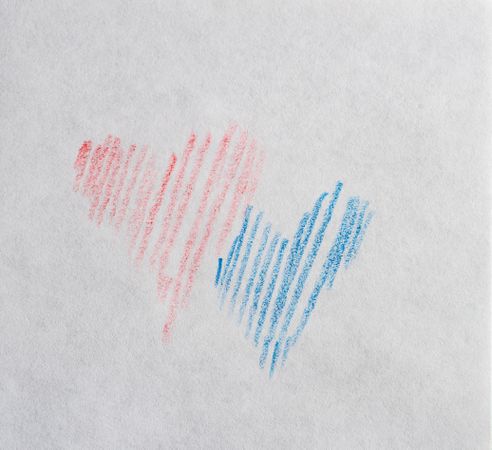 Valentine Day holiday card concept with a blue and red heart scribbled on paper