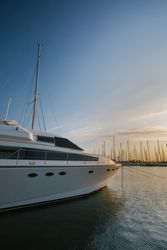 Luxury yachts in port at sunset