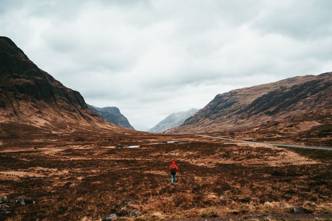 Person walking through picturesque mountains
