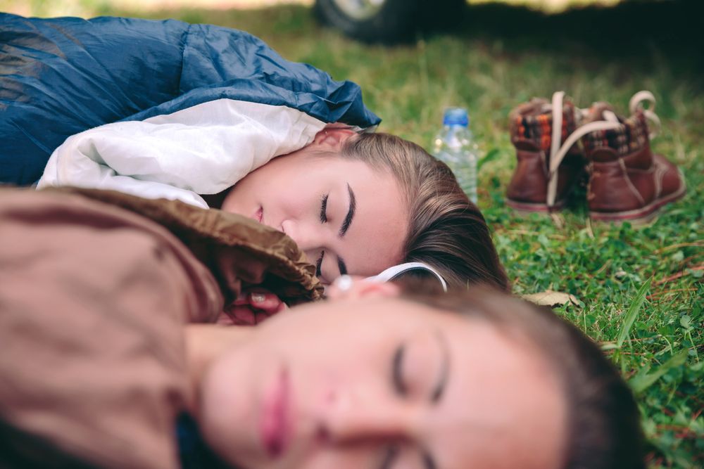 Women resting in the nature inside of sleeping bags