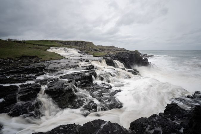 Waves breaking on shore on stormy day
