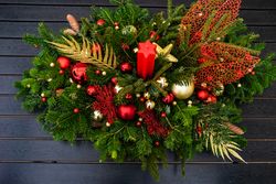 Holiday center piece with branches, baubles with candle