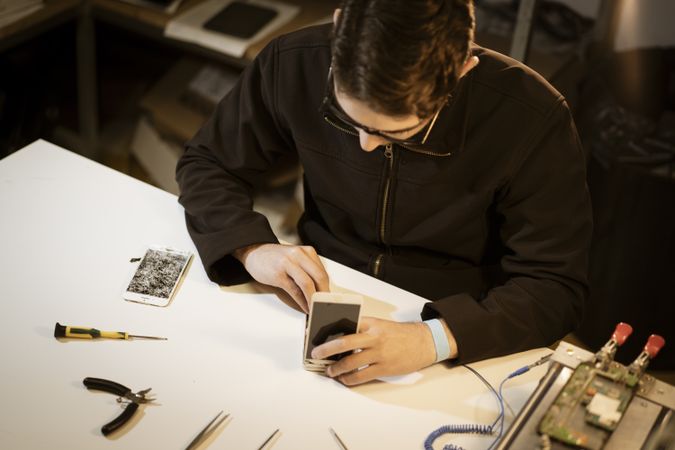 Young man repairing modern device