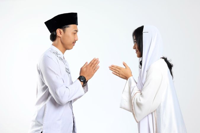 Asian Couple Forgiving Each Other by Giving Greets Hand During Eid Mubarak Celebration