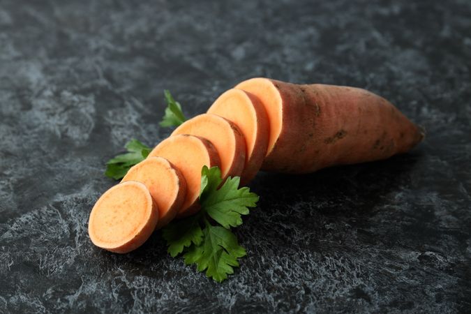 Fresh cut sweet potato on a dark background