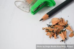 Pencil laying on table with shavings & sharpener 41ldql
