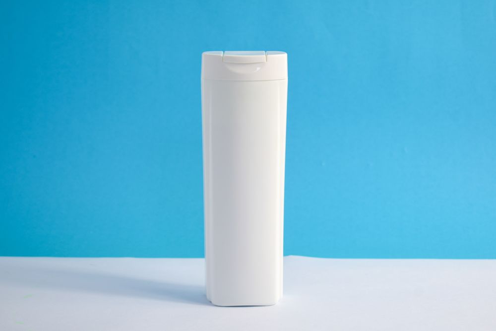 Blank shampoo bottle with blue background