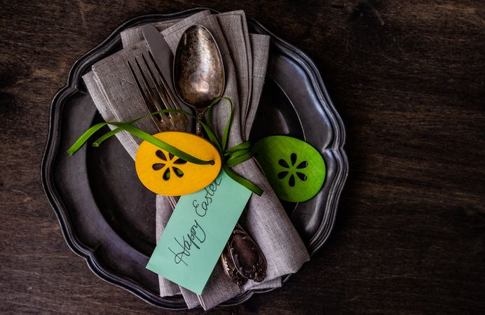Top view of silverware with happy Easter card