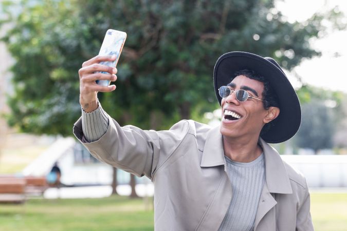 Stylish man taking selfie on smartphone