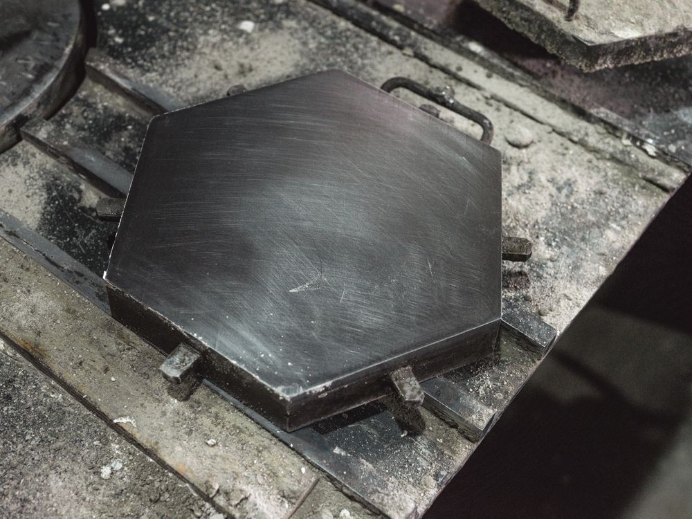 Metal mold for making hexagonal tile on table
