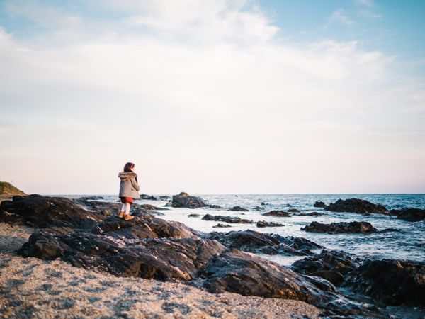 back view of little girl looking at sea