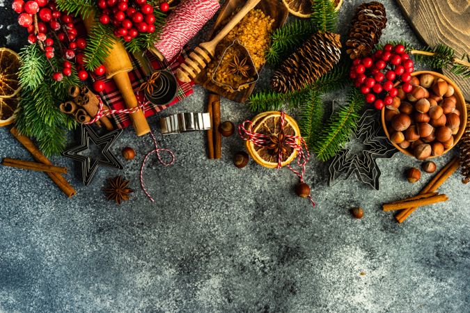 Christmas baking equipment and branches on concrete counter with copy space