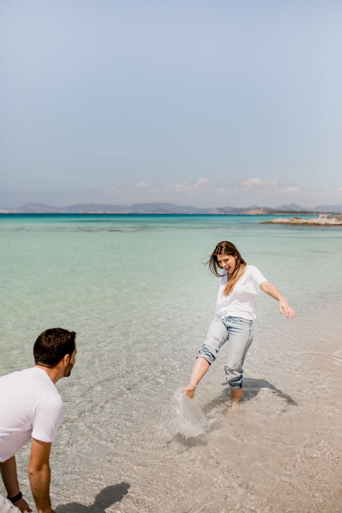 Cheerful lovers having fun on tropical coastline