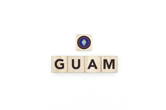 Wooden blocks bearing the name and flag of Guam.