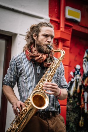 Male saxophonist plays Sax in the street