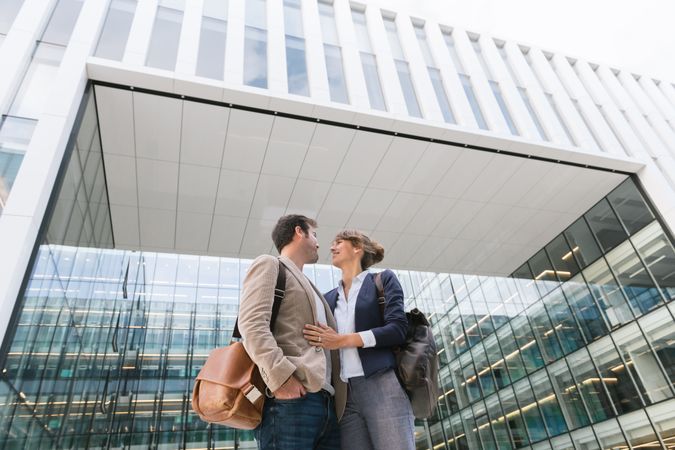 Businesspeople couple outside contemporary building