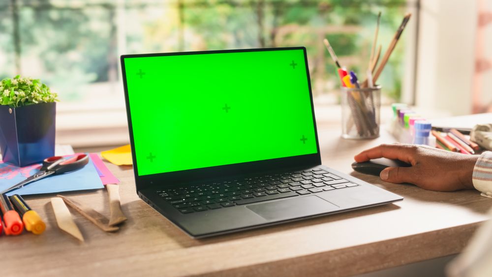 Art Student Holding a Modern Tablet in Front of a Camera. Computer with Green Screen Chroma Key Template for Digital Marketing, Promotion of Online Services, Apps, Software, Media Campaigns