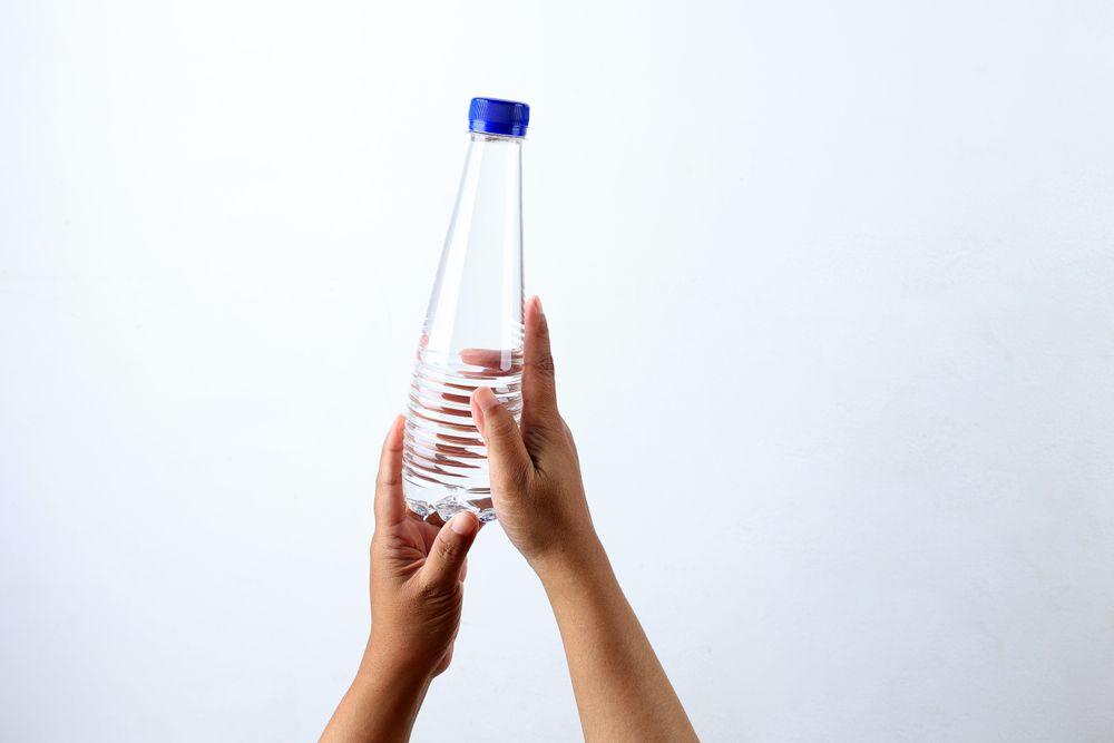 Woman Hand Holding A Bottle of Mineral Water