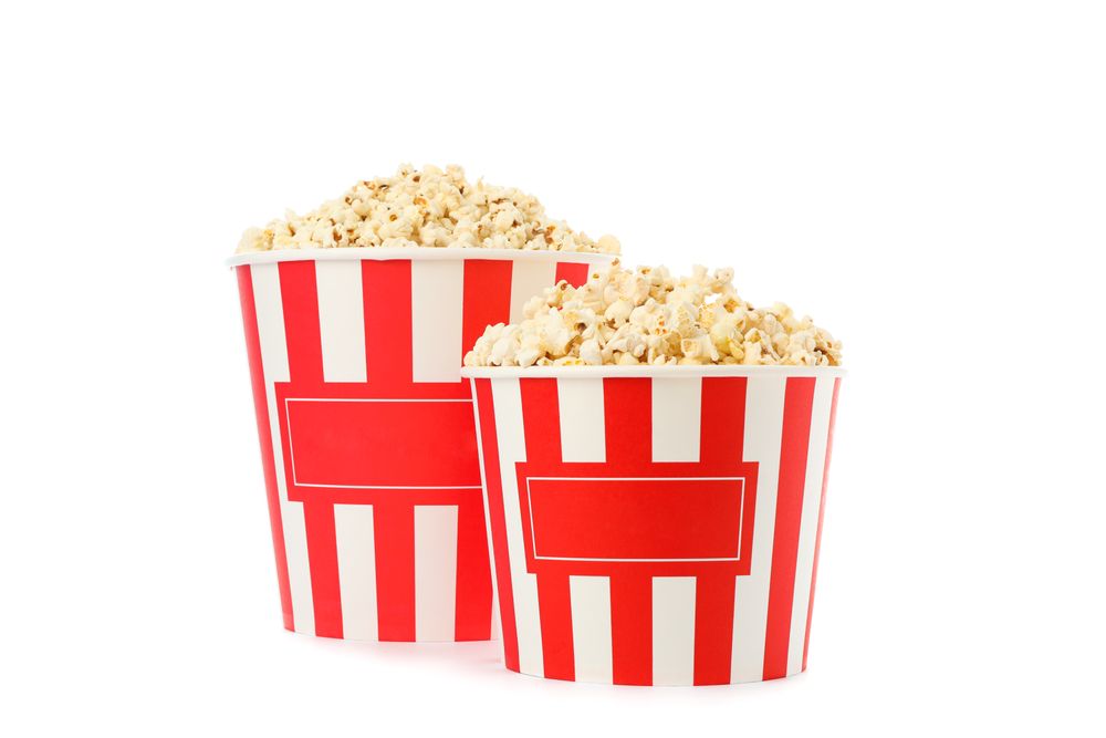 Striped buckets with popcorn isolated on blank background
