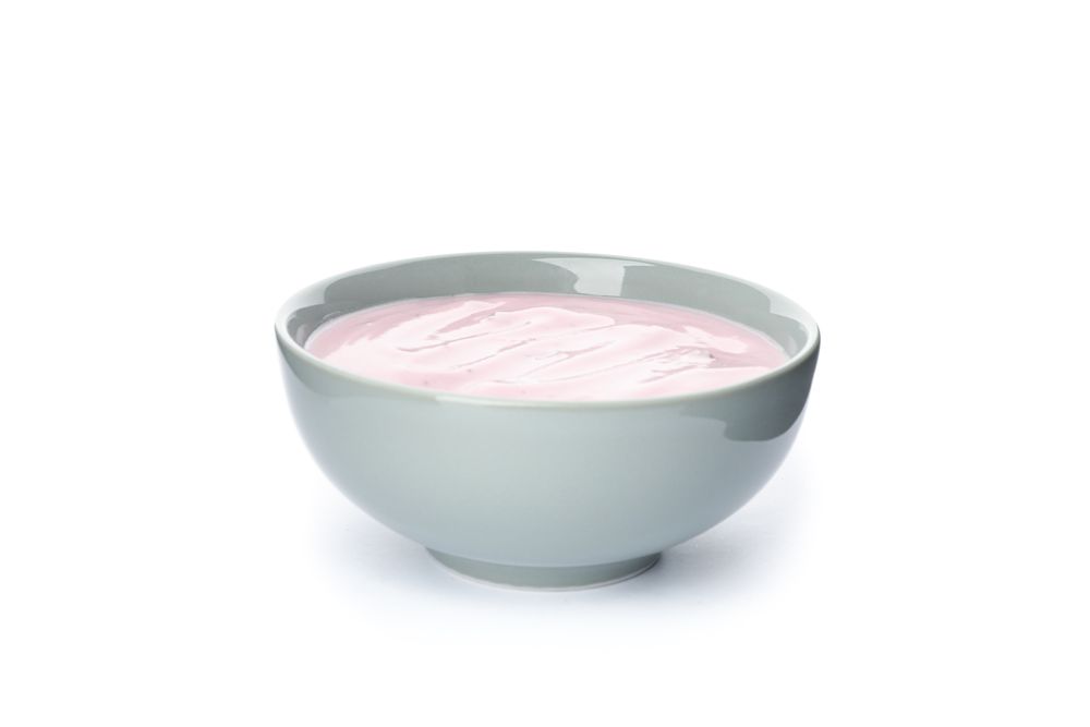 Bowl with fruit yogurt isolated on plain background