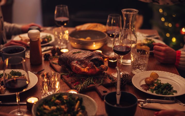 Dining table with comfort food and wine during Christmas dinner