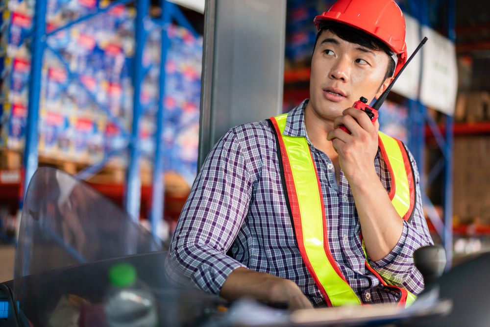 Man in PPE gear using walkie talkie