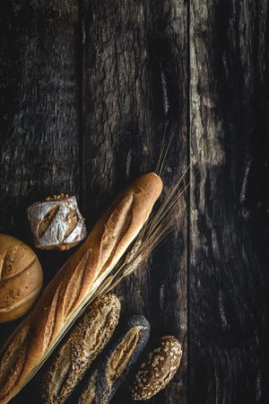 Assorted gold homemade bread on dark wood background