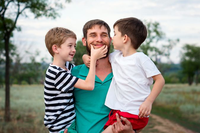 Loving father with two sons outdoors