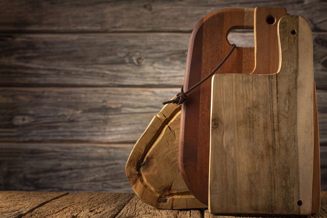 Wooden kitchen utensils on rustic background.