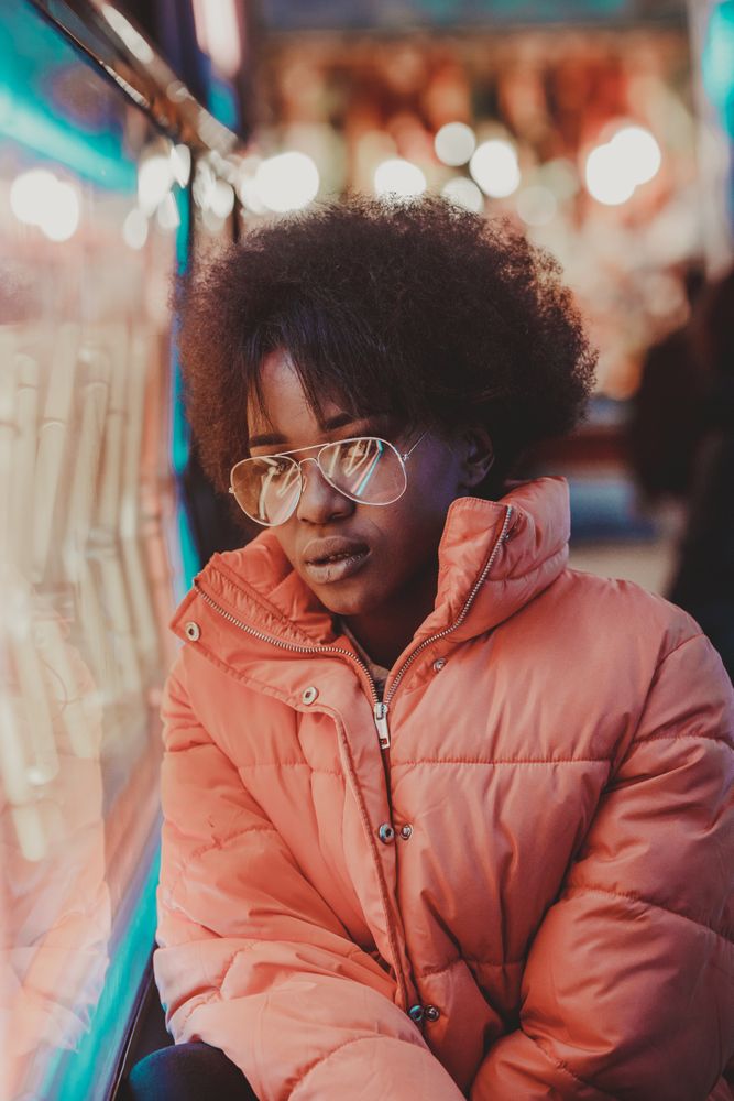Black woman standing on night city street