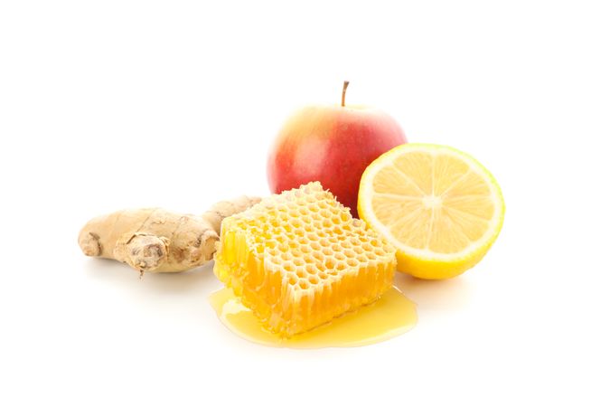 Honeycomb, apple, lemon and ginger isolated on neutral background