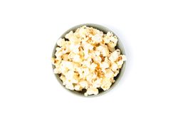 Bowl with popcorn isolated on blank background, top view