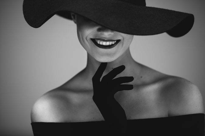 Elegant beautiful woman in a dress and hat